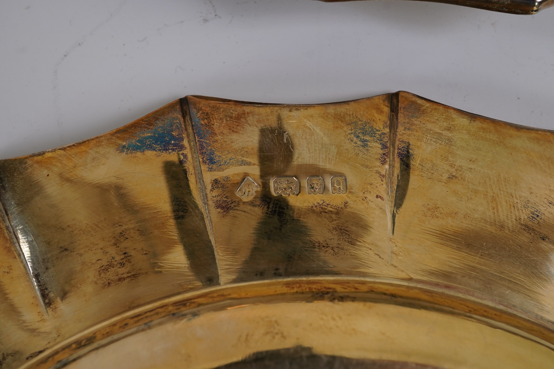 A set of twelve George V silver gilt side plates by J.S. Harman & Co